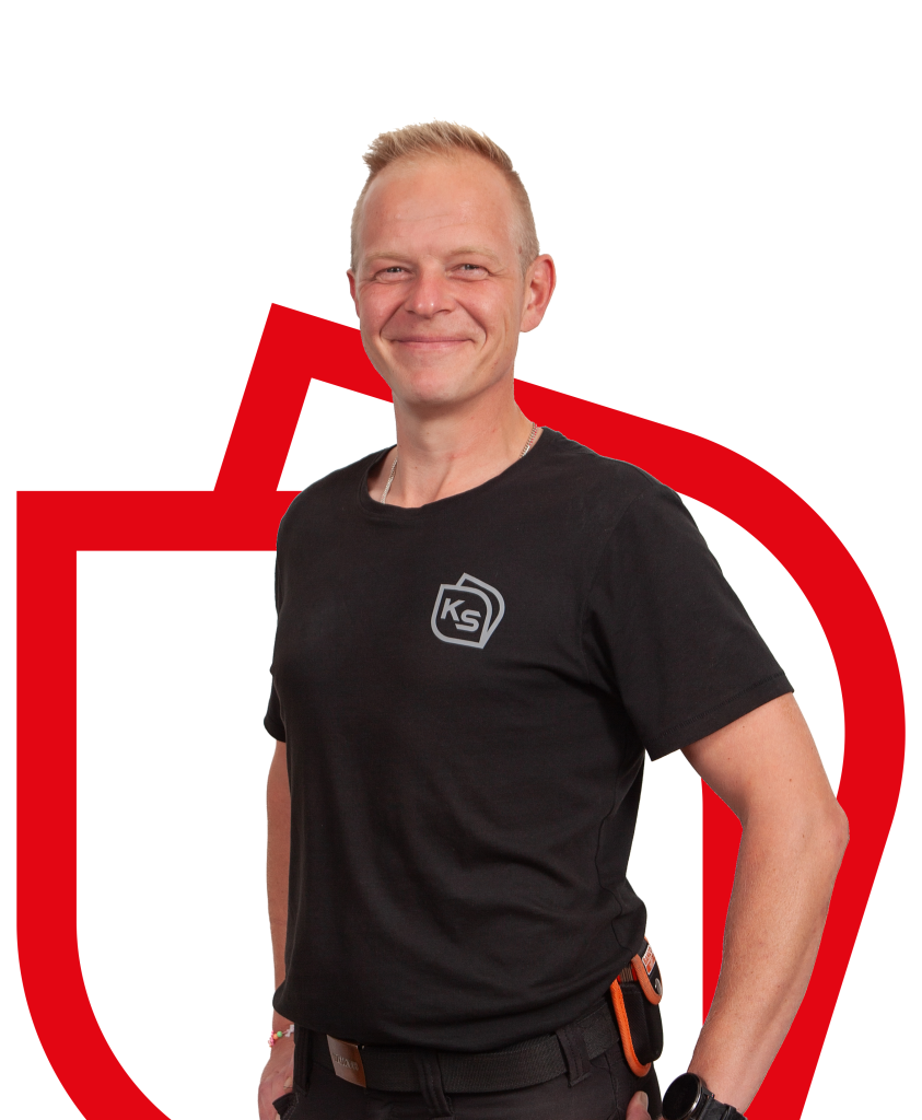 Vaaleahiuksinen mieshenkilö katsoo suoraan kohti ja hymyilee leveästi, taustalla on punaisella yrityksen logon ääriviivat.